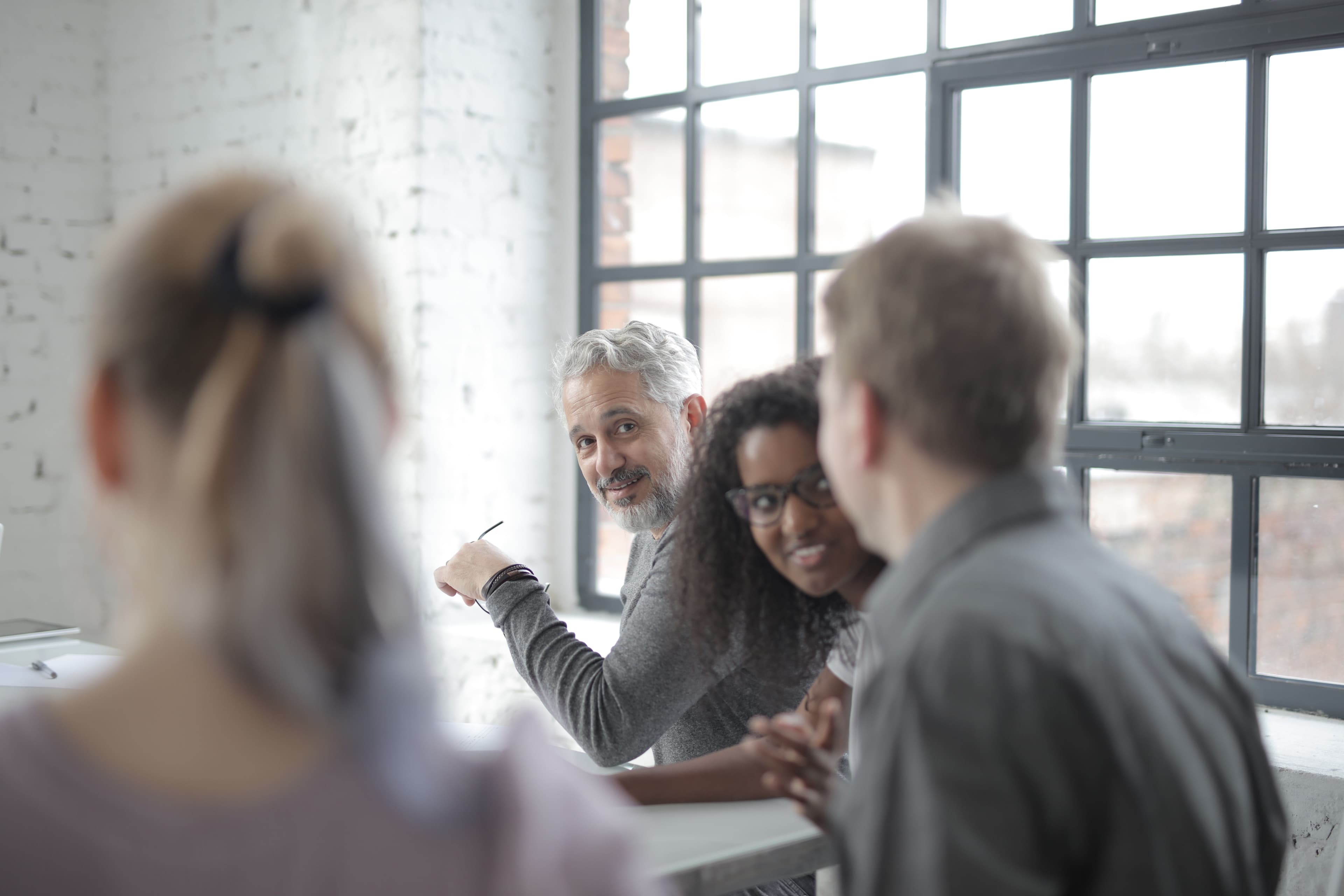 Professionals sharing ideas in a bright collaborative workspace